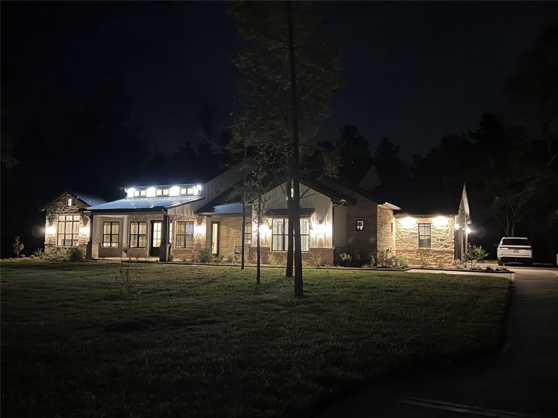It's all about the lighting.  The nighttime ambiance is so evident in this home.  Cleverly positioned luxurious and elegant outdoor lighting with the large and beautiful glass encased Hinkley lanterns.