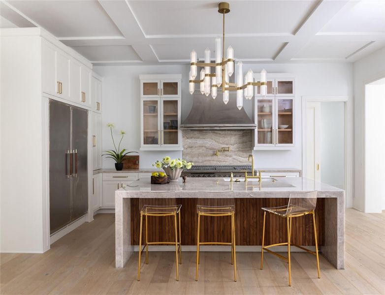 Equipped with L'Atelier Paris appliances, the chef's dream kitchen includes a waterfall edge island and gold hardware Equipped with L'Atelier Paris appliances, the chef's dream kitchen includes a waterfall edge island and gold hardware