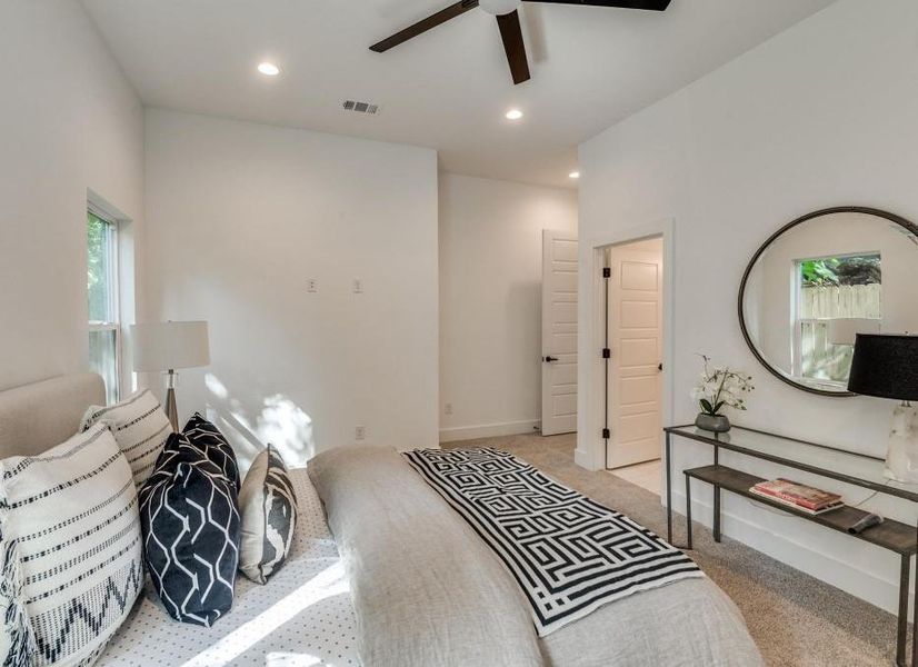 Bedroom featuring light carpet and ceiling fan