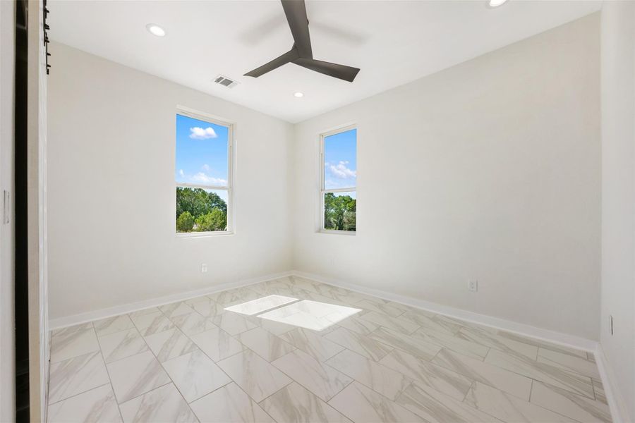 Bedroom #2 off foyer. All rooms have gorgeous white marble-look tile.