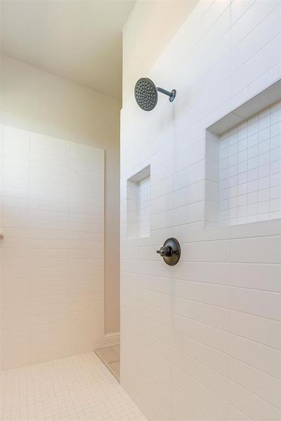 Bathroom featuring tiled shower