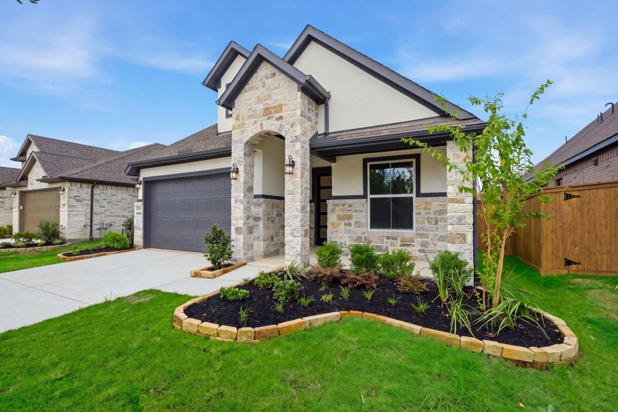 Front exterior of a new home in The Highlands, Porter, TX, highlighting curb appeal (Image 2). Front exterior of a new home in The Highlands, Porter, TX, highlighting curb appeal (Image 2).