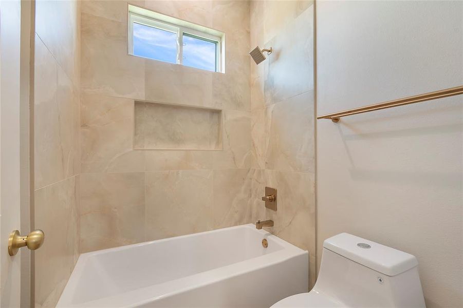 Bathroom featuring toilet and shower / washtub combination Bathroom featuring toilet and shower / washtub combination