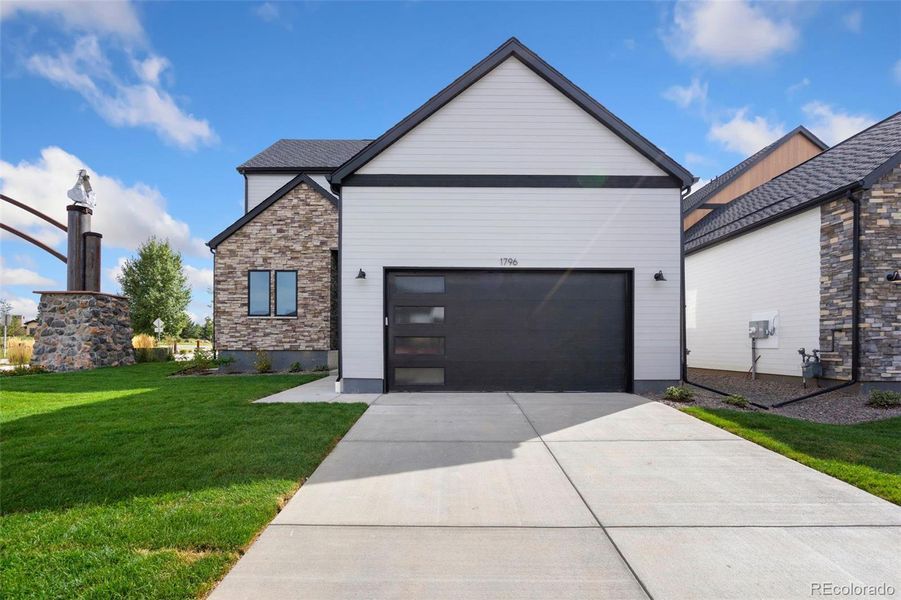 Front exterior of a new home in Pelican Shores at Water Valley, Windsor, CO, highlighting curb appeal (Image 2). Front exterior of a new home in Pelican Shores at Water Valley, Windsor, CO, highlighting curb appeal (Image 2).