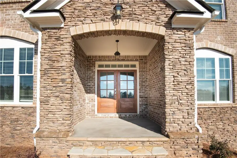 Exterior details and patio area of a home in The Estates at Hurricane Pointe, Douglasville (Image 3).
