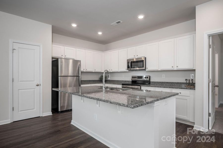 Kitchen with granite countertops and stainless appliances