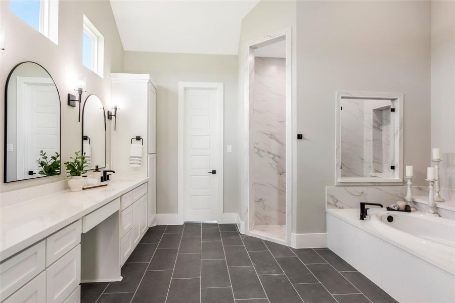 This bathroom features a modern design with dual sinks, sleek black fixtures, and large mirrors. This bathroom features a modern design with dual sinks, sleek black fixtures, and large mirrors.