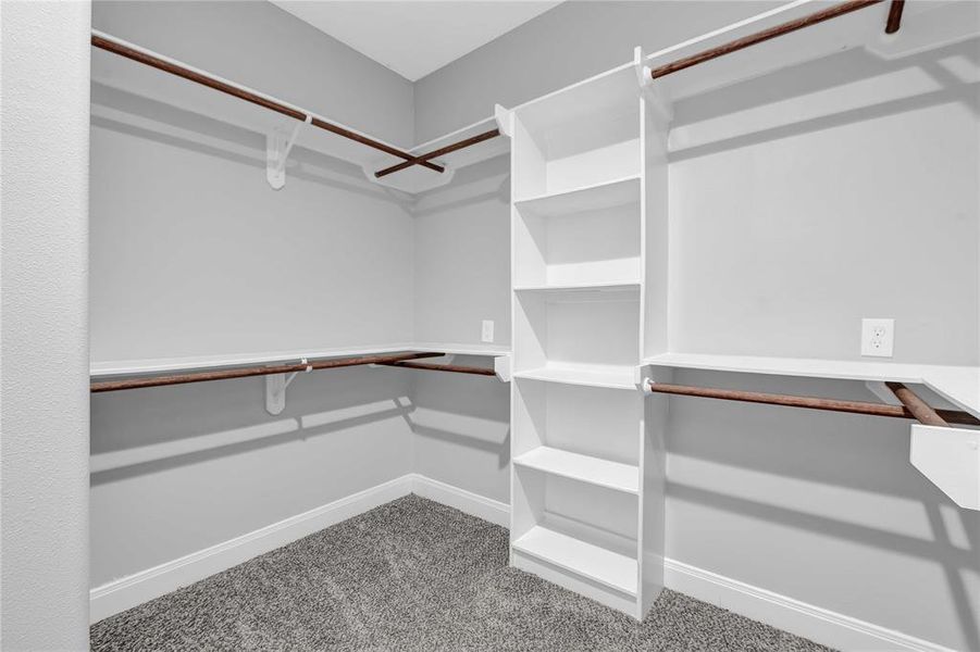 Walk in closet with custom built in racks.