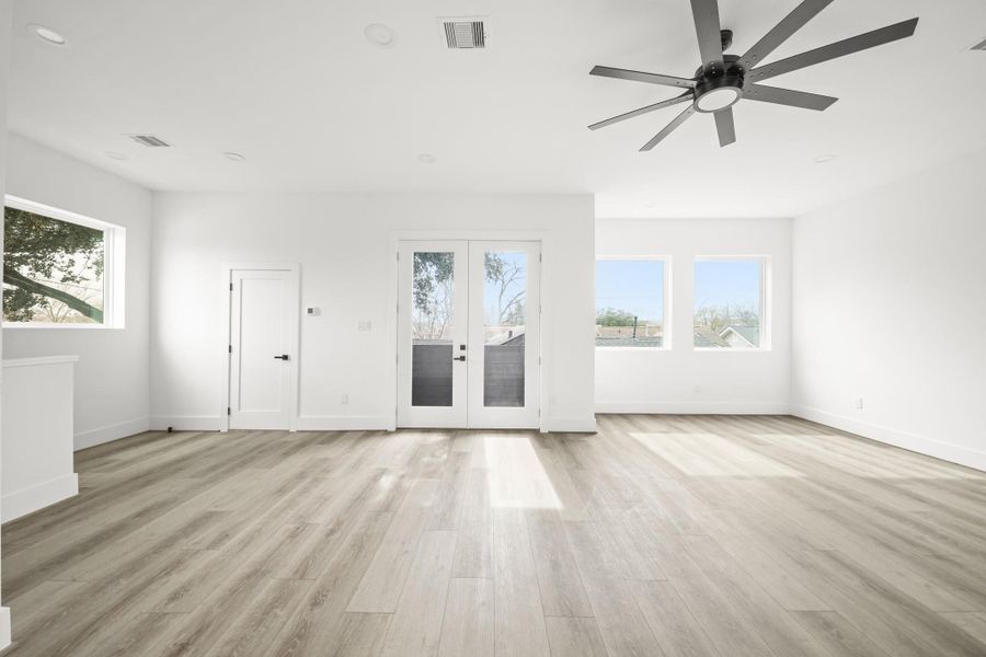 Natural light fills the living areas with multiple fixed windows and the 8-foot tall French Doors leading to the balcony. Natural light fills the living areas with multiple fixed windows and the 8-foot tall French Doors leading to the balcony.