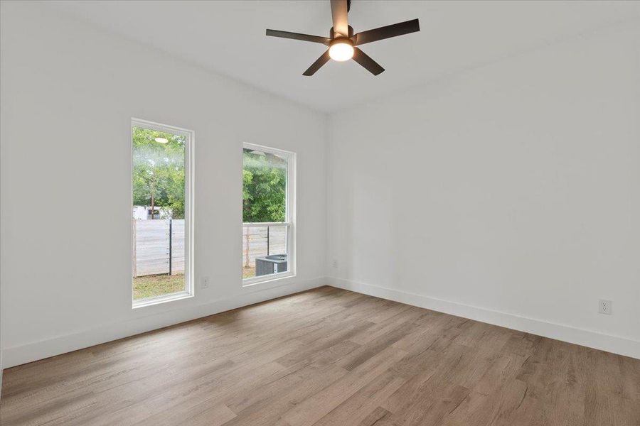 Unfurnished room featuring light wood-type flooring and a ceiling fan Unfurnished room featuring light wood-type flooring and a ceiling fan
