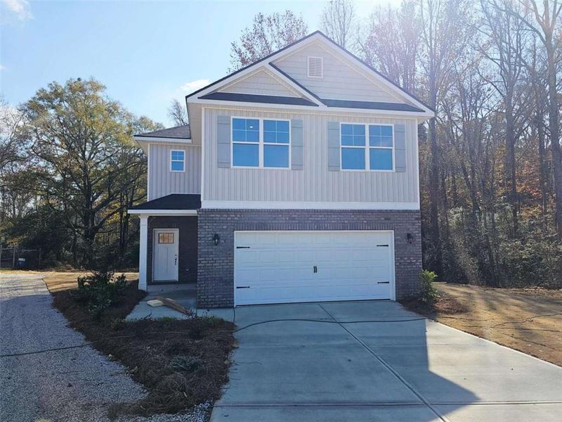 Front exterior of a new home in Scarlett Place, Bowdon, GA, highlighting curb appeal (Image 1). Front exterior of a new home in Scarlett Place, Bowdon, GA, highlighting curb appeal (Image 1).