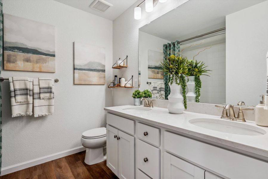 A bathroom with a large mirror. A bathroom with a large mirror.