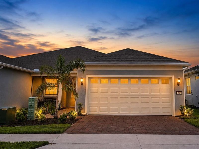 Front exterior of a new home in Del Webb Oasis, Winter Garden, FL, highlighting curb appeal (Image 2). Front exterior of a new home in Del Webb Oasis, Winter Garden, FL, highlighting curb appeal (Image 2).