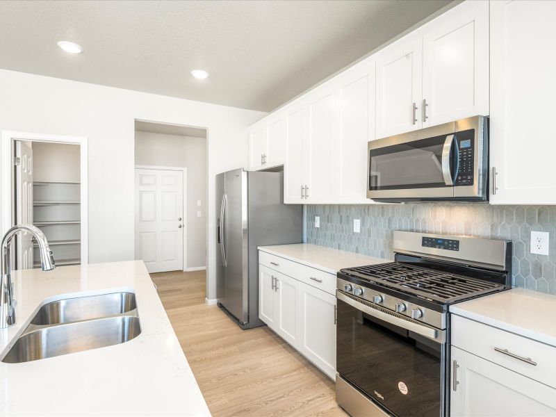 Kitchen in the Wateron floorplan at a Meritage Homes community in Brighton, CO.