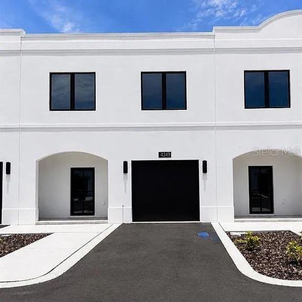 Front exterior of a new home in , Tampa, FL, highlighting curb appeal (Image 1). Front exterior of a new home in , Tampa, FL, highlighting curb appeal (Image 1).