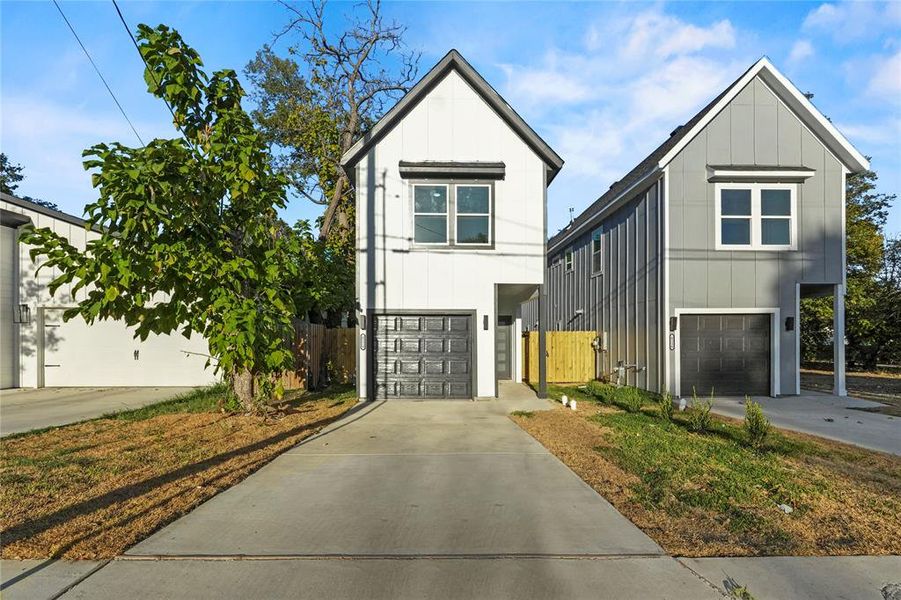 View of front of house featuring driveway, board and batten siding, and a garage View of front of house featuring driveway, board and batten siding, and a garage