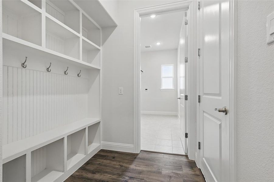 Mudroom with baseboards, visible vents, and dark wood-type flooring
