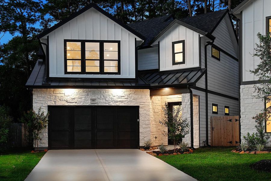 Front exterior of a new home in , The Woodlands, TX, highlighting curb appeal (Image 1). Front exterior of a new home in , The Woodlands, TX, highlighting curb appeal (Image 1).