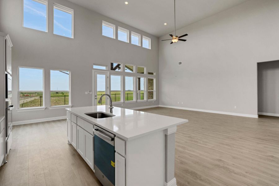 Kitchen with light wood-type flooring, dishwasher, open floor plan, ceiling fan, and recessed lighting Kitchen with light wood-type flooring, dishwasher, open floor plan, ceiling fan, and recessed lighting