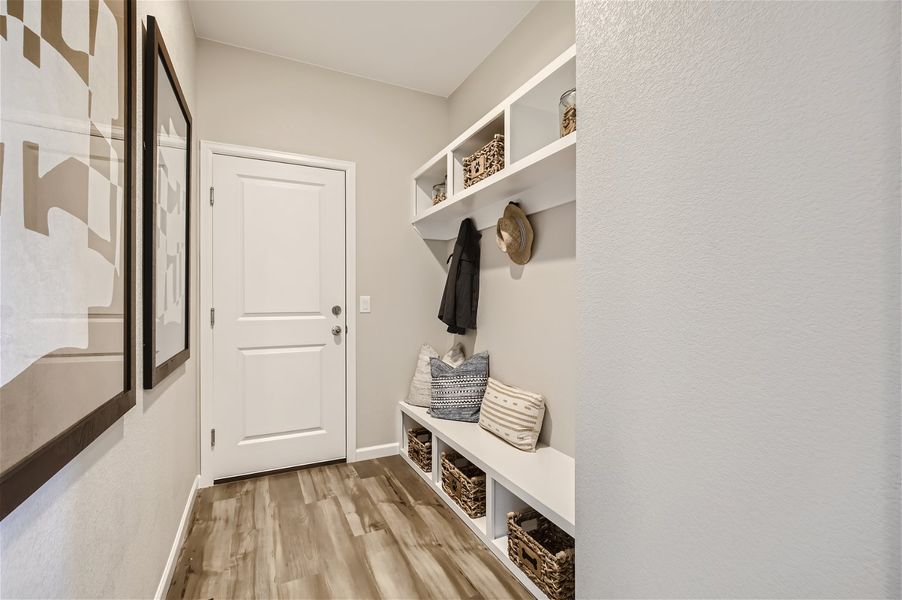 A room with a white door and shelves with objects on them. A room with a white door and shelves with objects on them.