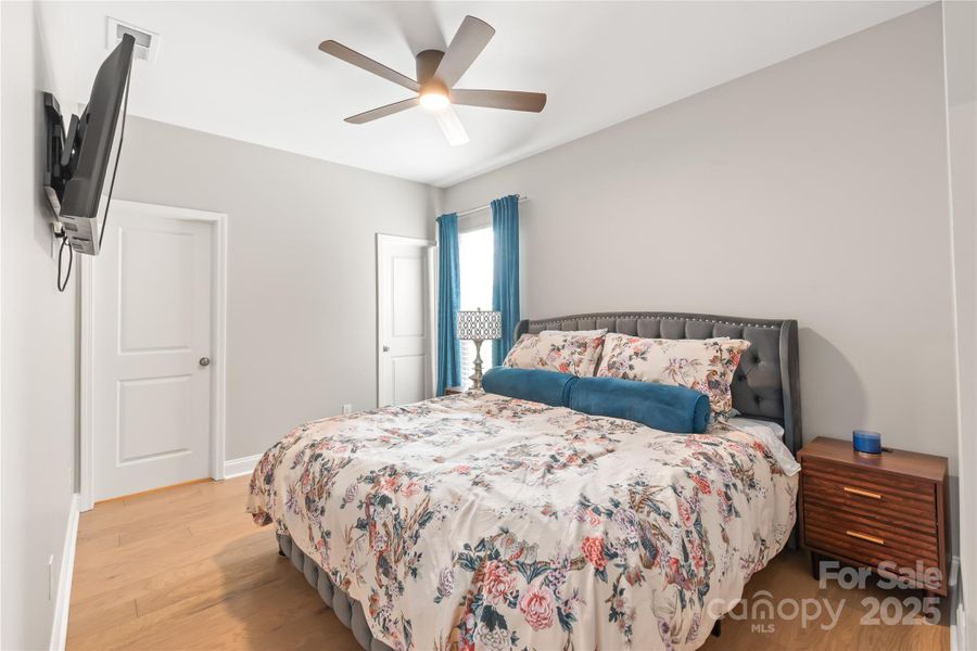 Main level guest room with a walk-in closet and an ensuite bath. Main level guest room with a walk-in closet and an ensuite bath.