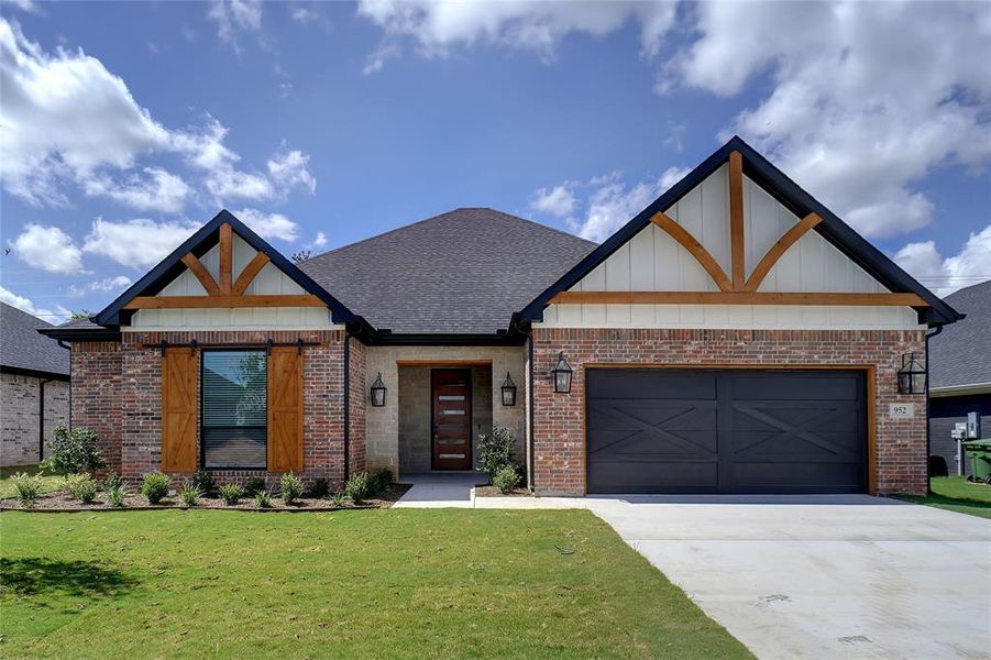 View of front of house with a front lawn and a garage