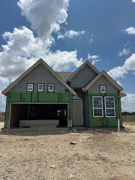 A newly framed residence awaits its finishing touches, showcasing clean lines under a bright sky. A newly framed residence awaits its finishing touches, showcasing clean lines under a bright sky.