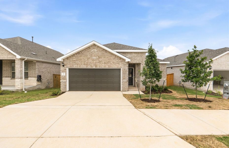 Front exterior of a new home in La Cima, San Marcos, TX, highlighting curb appeal (Image 19).