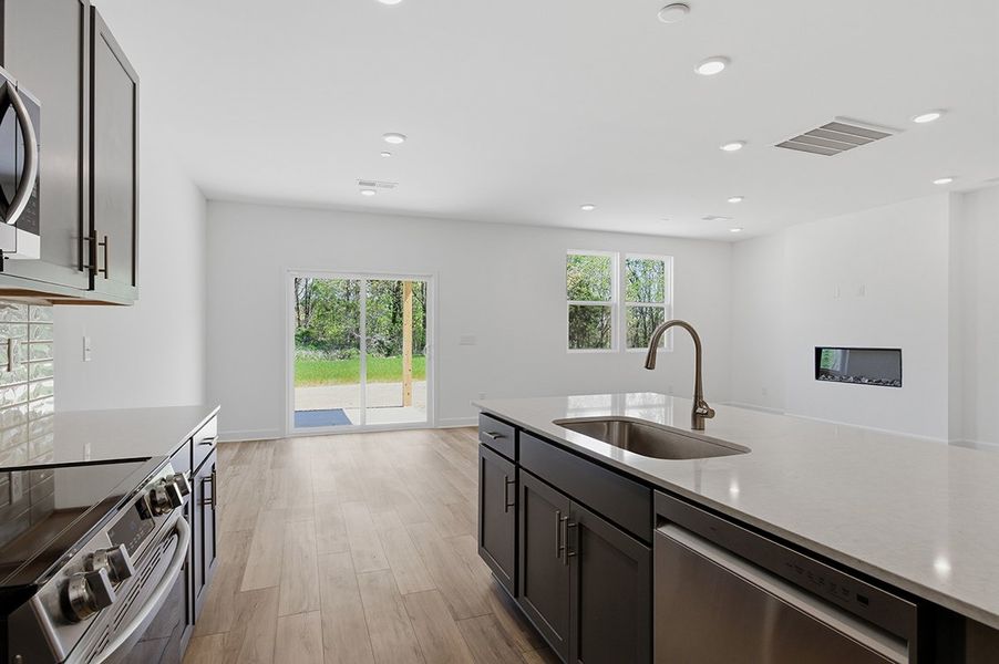 A kitchen with a wood floor. A kitchen with a wood floor.