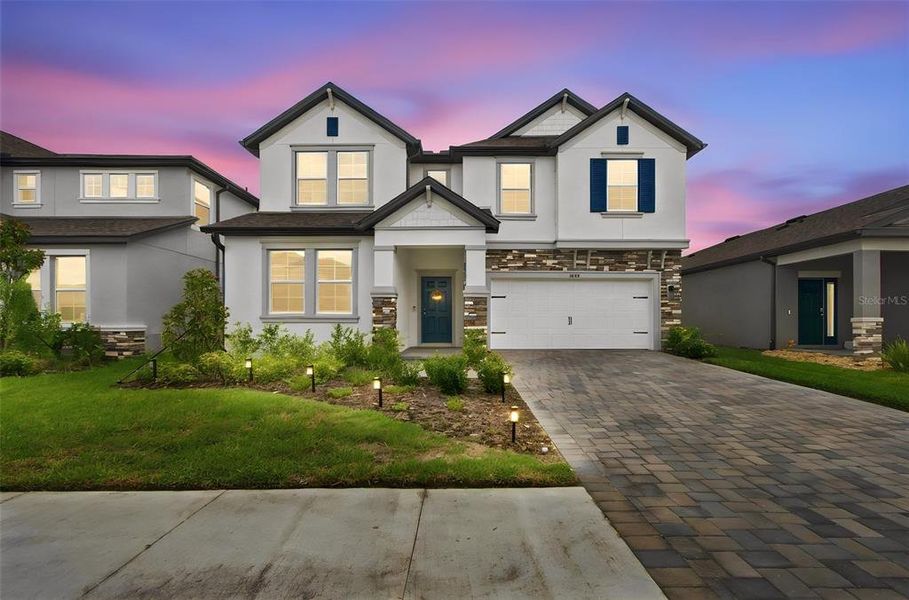 Front exterior of a new home in Epperson, Wesley Chapel, FL, highlighting curb appeal (Image 22). Front exterior of a new home in Epperson, Wesley Chapel, FL, highlighting curb appeal (Image 22).