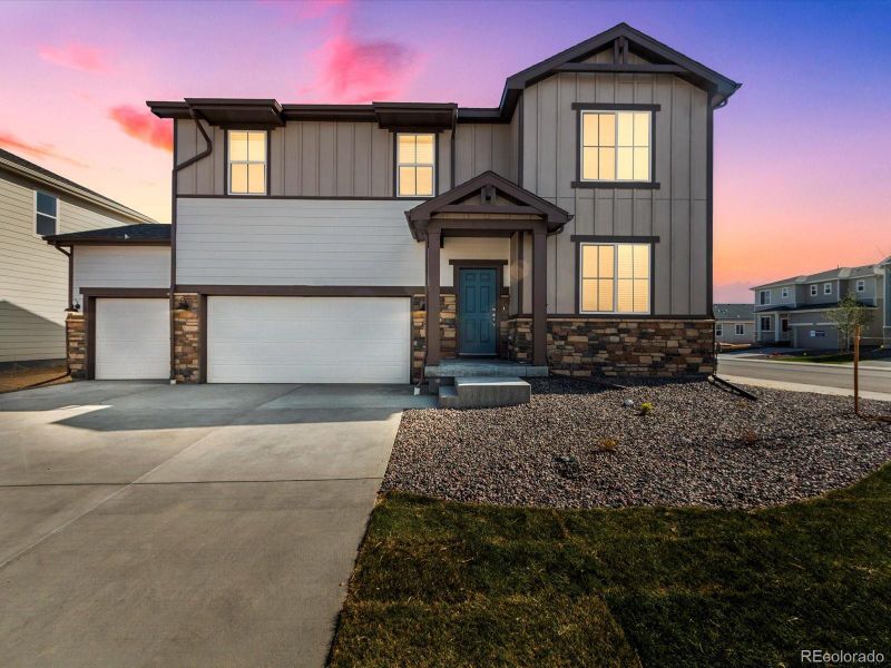 Front exterior of a new home in Revere at Johnstown, Johnstown, CO, highlighting curb appeal (Image 1).