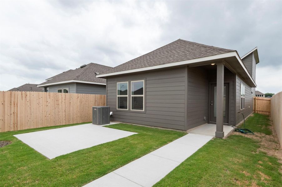 Rear view of property with a patio, roof with shingles, and a fenced backyard