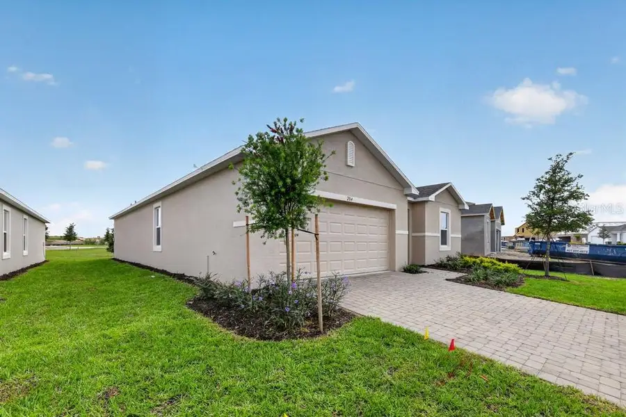 Front exterior of a new home in Waterstone, Groveland, FL, highlighting curb appeal (Image 29).