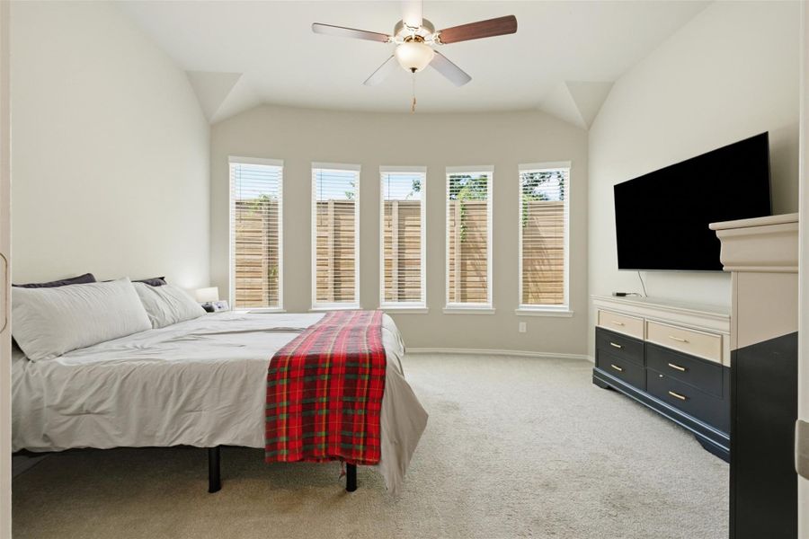 Spacious primary suite featuring soaring ceilings, abundant natural light, and a wall of windows that creates a bright and relaxing retreat. Spacious primary suite featuring soaring ceilings, abundant natural light, and a wall of windows that creates a bright and relaxing retreat.