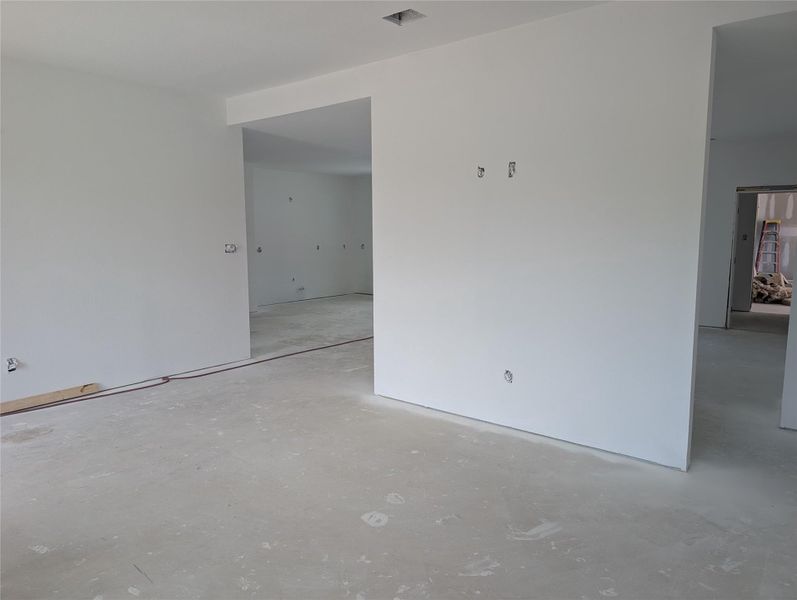 Expansive interior space with smooth drywall finishes and recessed lighting
