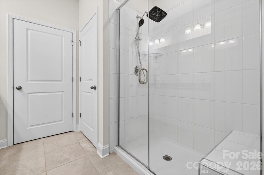 Spacious shower with bench.
