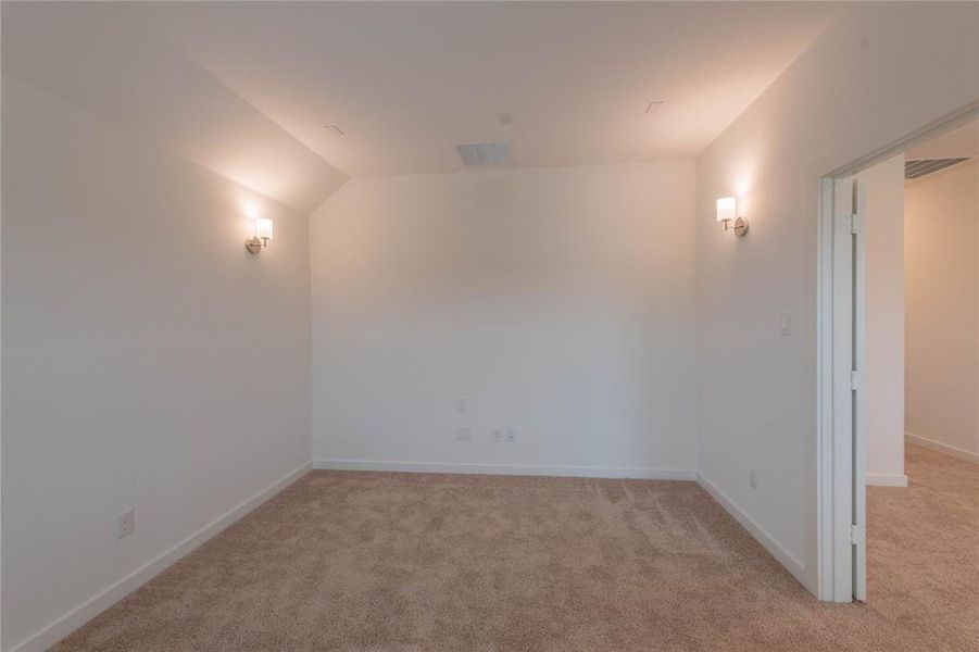 Unfurnished living room with vaulted ceiling, plenty of natural light, light wood-type flooring, and a glass covered fireplace