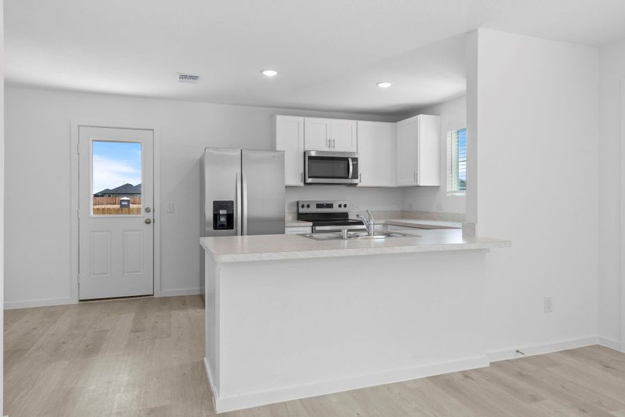 Furnished interior view inside a new home in The Courtyards at Stokesbury, Waller (Image 6).