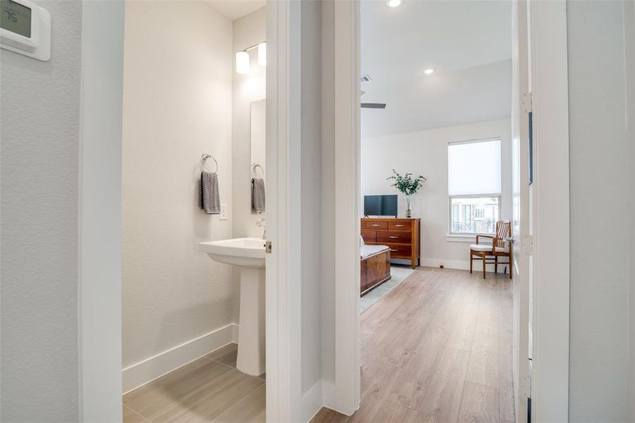 The half bath is just outside of the master bedroom.  The luxury vinyl flooring continues into the master bedroom.