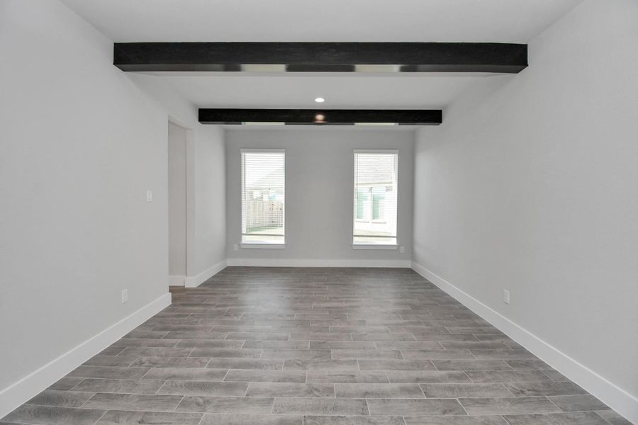 Make memories gathered around the table with your family and friends! This spacious dining room features elegant flooring, custom paint, and adjacent to family room and kitchen for open concept feel. Sample photo of completed home with similar floor plan. Actual colors and selections may vary.