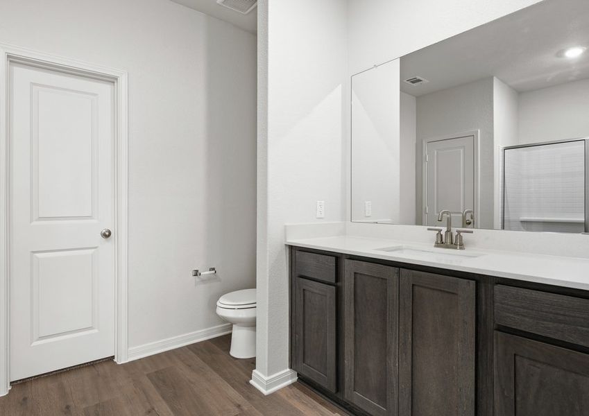 The master bathroom has a sprawling vanity.