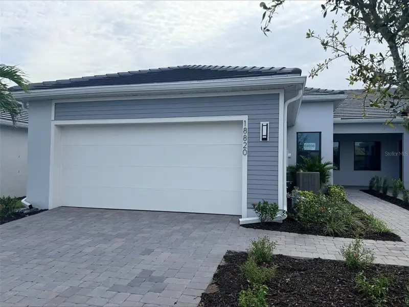 Front exterior of a new home in Del Webb Catalina, Lakewood Ranch, FL, highlighting curb appeal (Image 1). Front exterior of a new home in Del Webb Catalina, Lakewood Ranch, FL, highlighting curb appeal (Image 1).