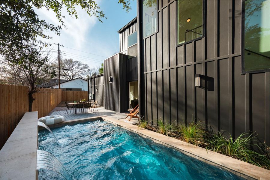 View of pool featuring outdoor dining area and a fenced backyard