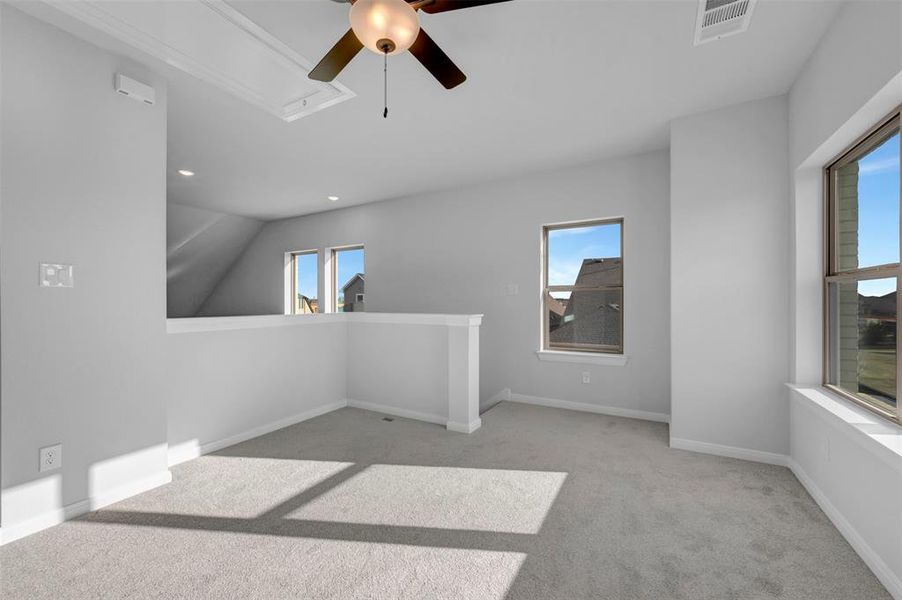 Empty room with a ceiling fan, light carpet, and recessed lighting Empty room with a ceiling fan, light carpet, and recessed lighting