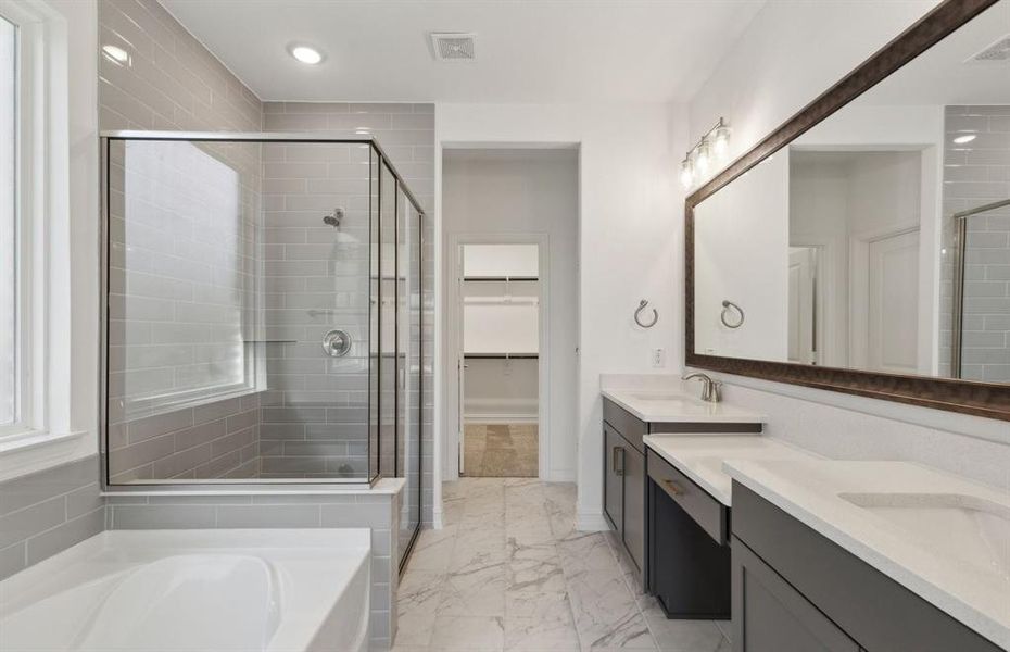 Spacious owner's bathroom with dual vanity and oversized shower*real home pictured