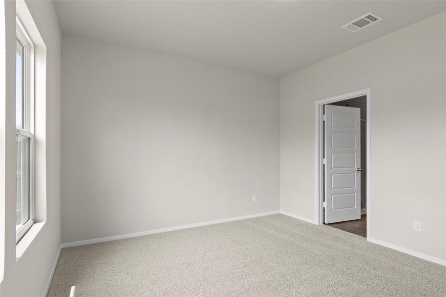 Unfurnished room featuring dark colored carpet and baseboards Unfurnished room featuring dark colored carpet and baseboards