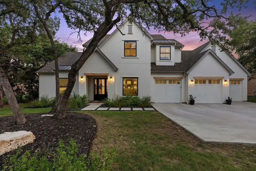 A striking contemporary residence boasts a pristine white facade, sleek black-framed windows, and ample garage space. A striking contemporary residence boasts a pristine white facade, sleek black-framed windows, and ample garage space.