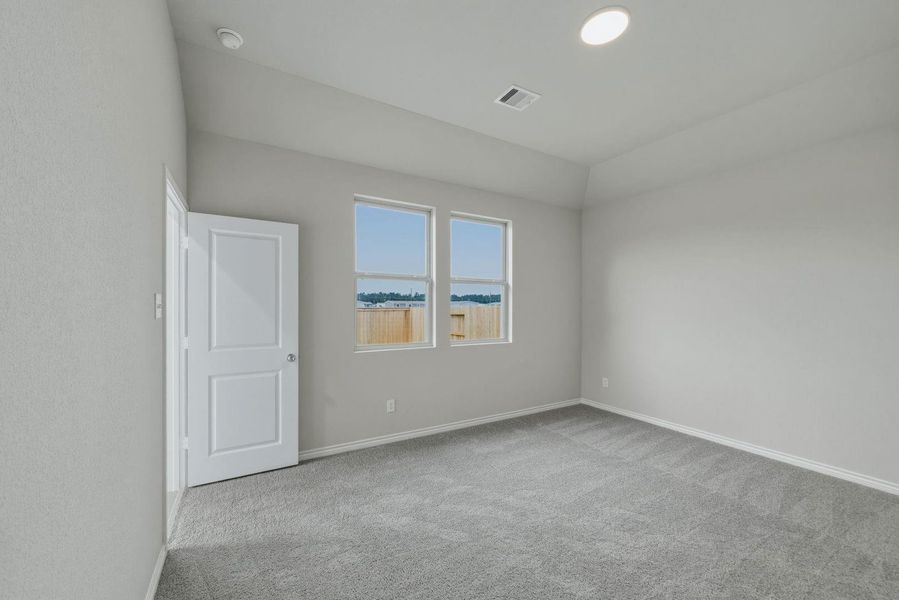Primary Bedroom in the Cedar home plan by Trophy Signature Homes – REPRESENTATIVE PHOTO