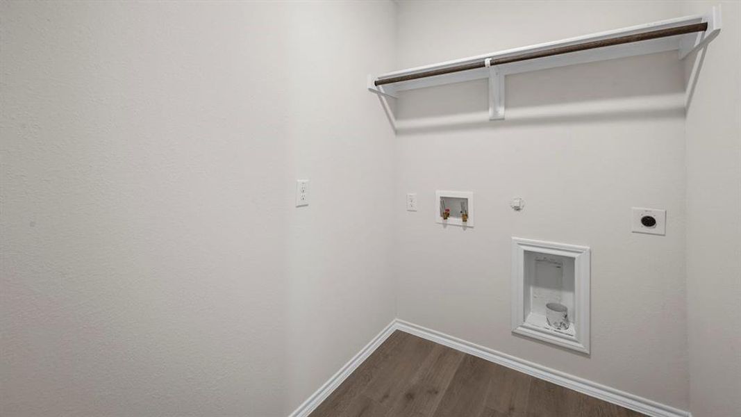 Laundry room with electric dryer hookup, hookup for a gas dryer, dark wood-style flooring, and hookup for a washing machine