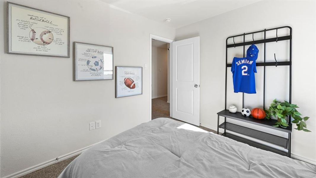 Carpeted bedroom featuring baseboards